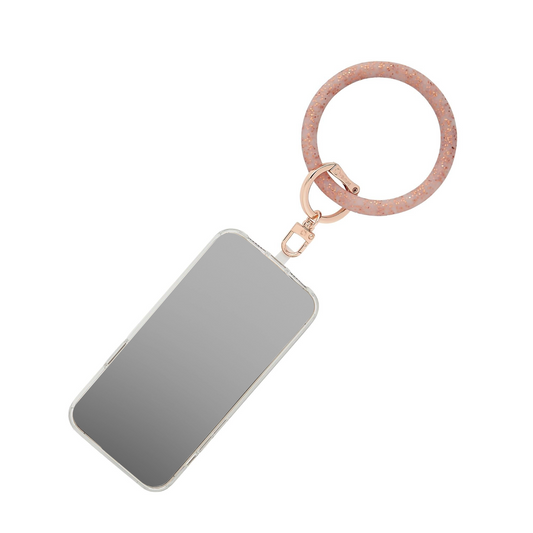 A stylish Big O Phone wristlet for handsfree convenience.  Shown in rose gold confetti silicone.
