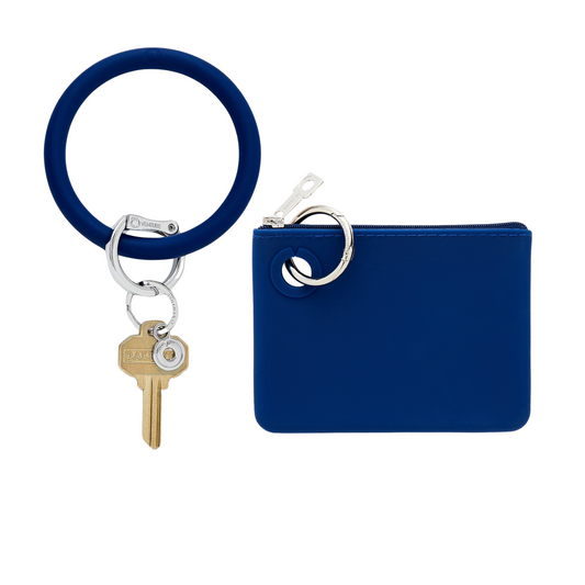 Mini pouch wristlet in smooth silicone material in navy blue.